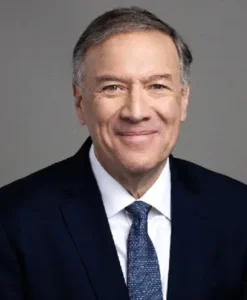 A man in suit and tie smiling for the camera.